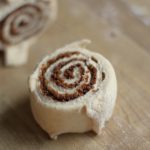 homemade sourdough cinnamon roll sitting on the counter freshly cut and ready to bake