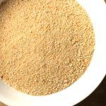 homemade sourdough breadcrumbs in a white bowl on the counter top